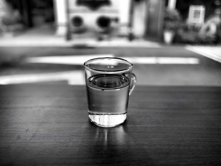 Grautufenfoto von einem Wasserglas