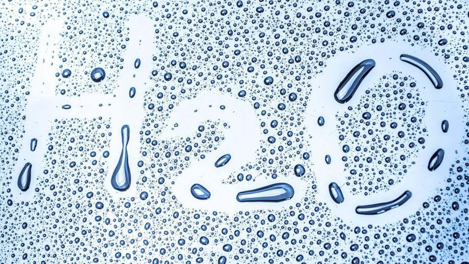 Schriftzug H2O in Wassertropfen