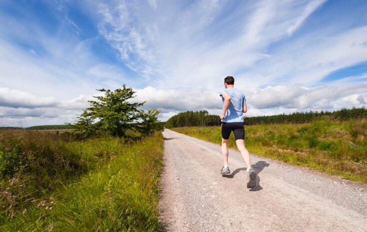 Ein Mann joggt einen Weg entlang